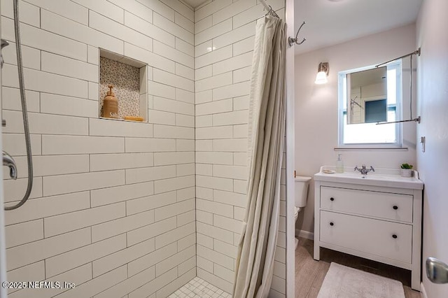 bathroom featuring vanity, toilet, and curtained shower