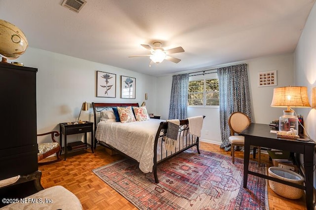 bedroom featuring ceiling fan and parquet flooring