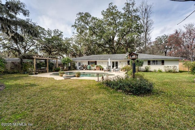 rear view of property featuring a pergola, a pool with hot tub, a patio area, and a lawn