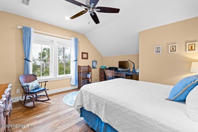 bedroom with ceiling fan, lofted ceiling, and wood-type flooring