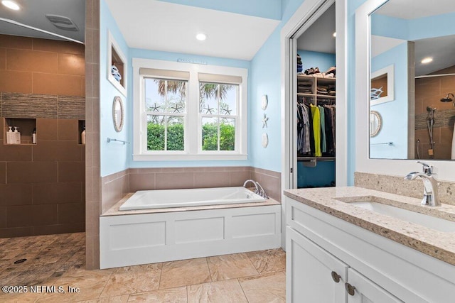 bathroom featuring vanity and separate shower and tub