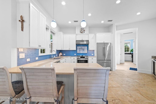 kitchen featuring pendant lighting, white cabinetry, and stainless steel appliances