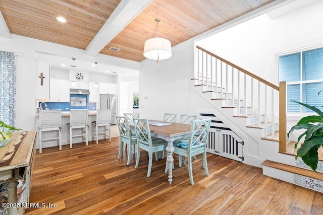 dining area with wood ceiling, radiator, light hardwood / wood-style floors, and beamed ceiling