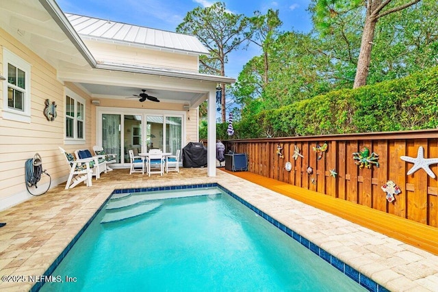 view of pool featuring a grill and ceiling fan