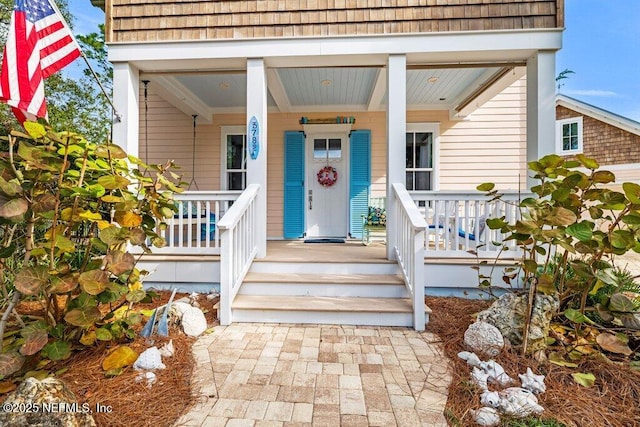 view of exterior entry featuring a porch