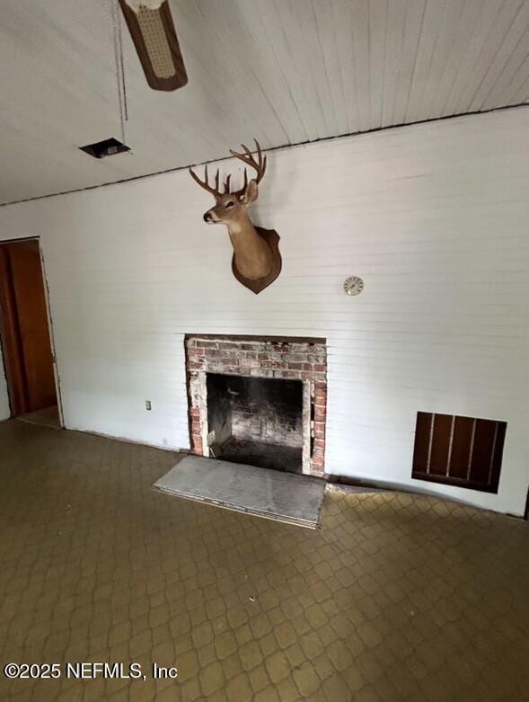 unfurnished living room featuring a fireplace and ceiling fan