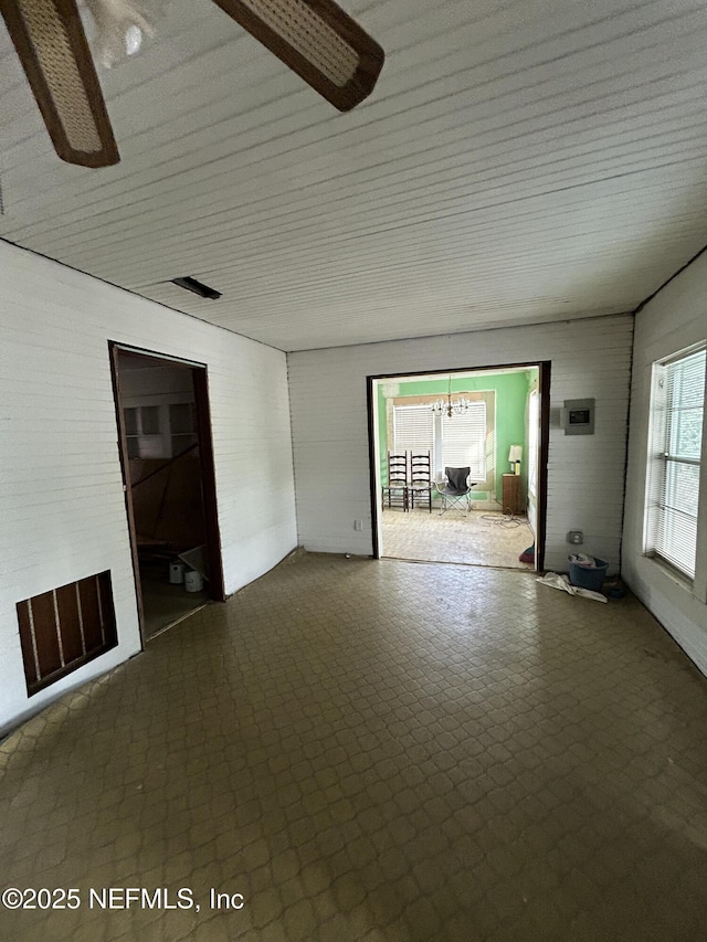 unfurnished living room with brick wall