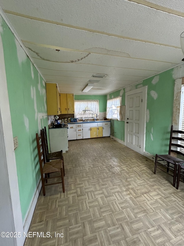 kitchen featuring a textured ceiling and light parquet floors