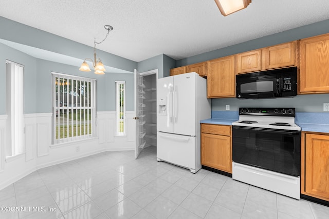 kitchen featuring electric range, hanging light fixtures, light countertops, white fridge with ice dispenser, and black microwave