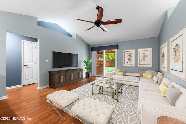 living room with vaulted ceiling, ceiling fan, wood finished floors, and baseboards