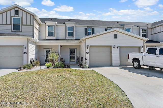 townhome / multi-family property with a garage and a front lawn