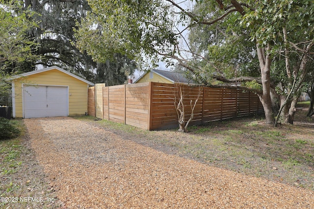 exterior space with an outbuilding and a garage