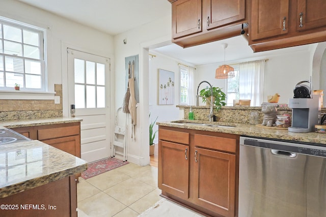 kitchen featuring dishwasher, plenty of natural light, sink, and pendant lighting