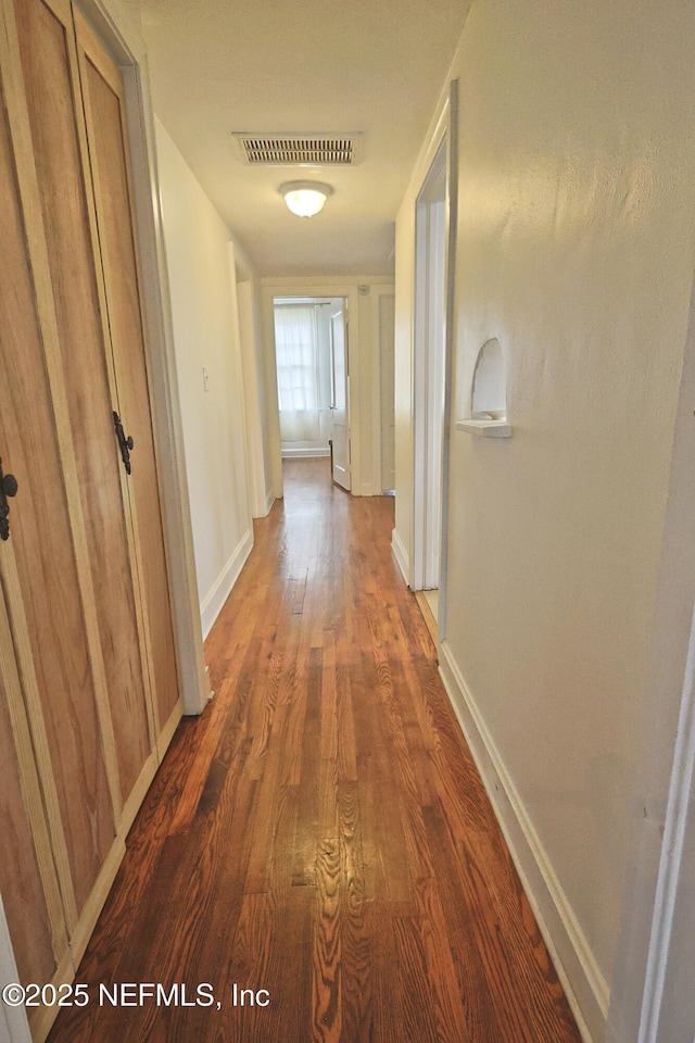 hallway featuring dark hardwood / wood-style floors