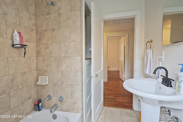 bathroom with sink, tile patterned floors, and tiled shower / bath