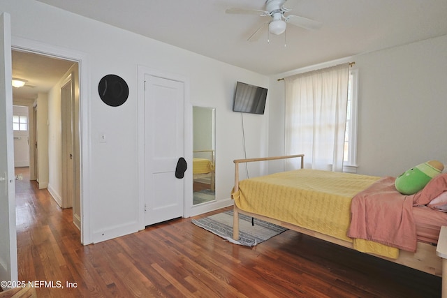 bedroom with dark hardwood / wood-style floors and ceiling fan