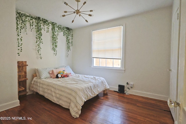 bedroom featuring dark wood-type flooring and a notable chandelier