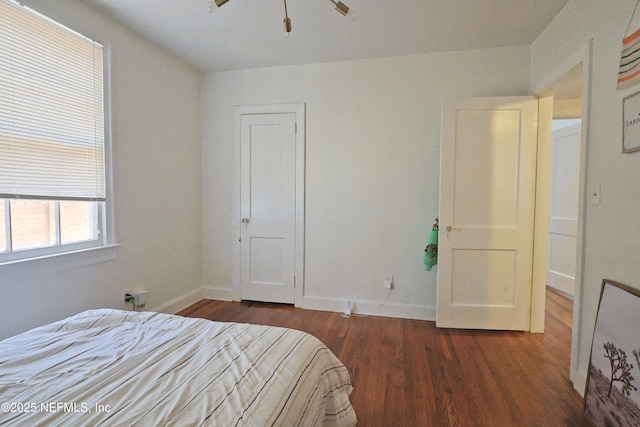 bedroom featuring ceiling fan and dark hardwood / wood-style floors