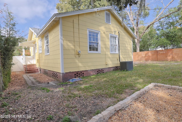 view of home's exterior featuring a yard and central AC unit