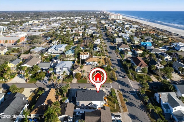 birds eye view of property with a beach view and a water view