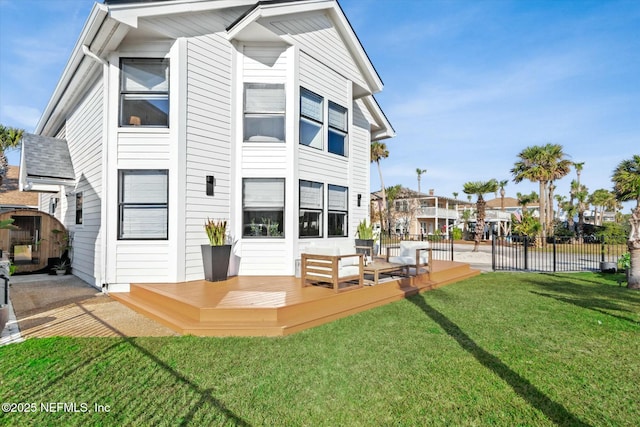 back of house with a wooden deck, a yard, and an outdoor hangout area