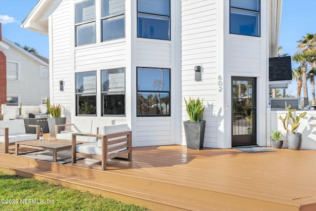 rear view of house featuring outdoor lounge area and a deck