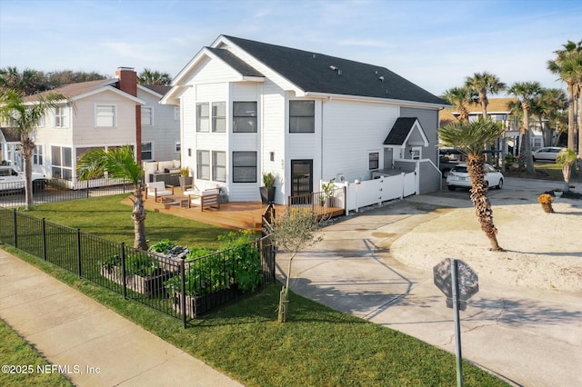 view of front facade with an outdoor hangout area, a front yard, and a deck