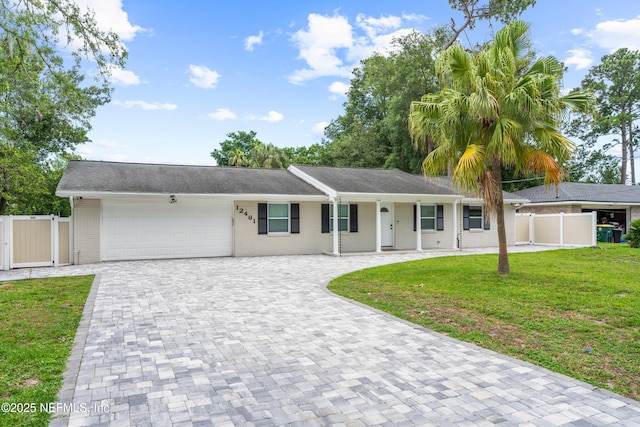 single story home featuring a garage and a front yard