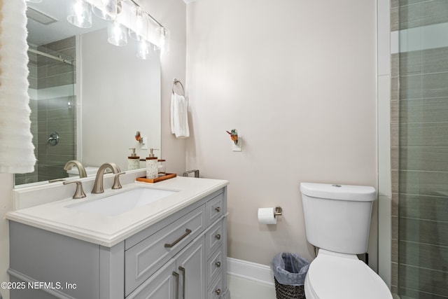 bathroom featuring an enclosed shower, vanity, and toilet