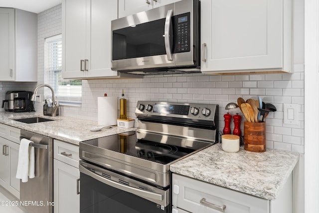 kitchen featuring white cabinetry, appliances with stainless steel finishes, and sink