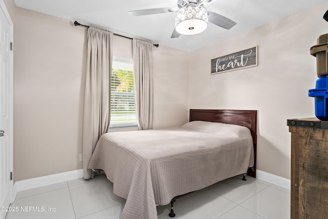 tiled bedroom featuring ceiling fan