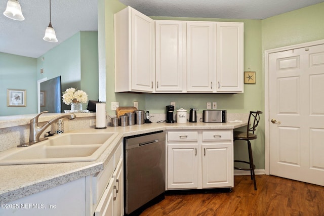 kitchen with white cabinetry, hanging light fixtures, sink, and dishwasher