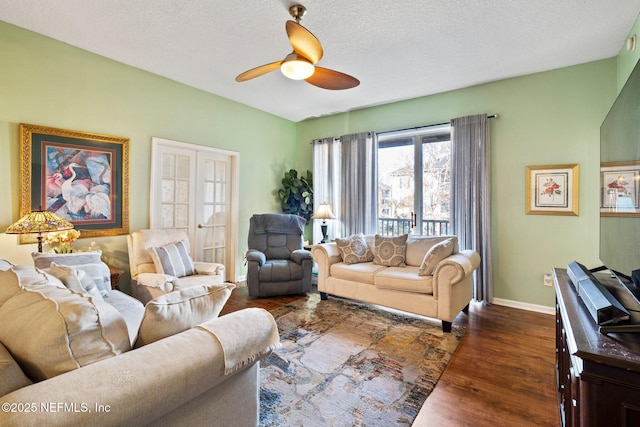 living room featuring a textured ceiling, dark hardwood / wood-style floors, and ceiling fan