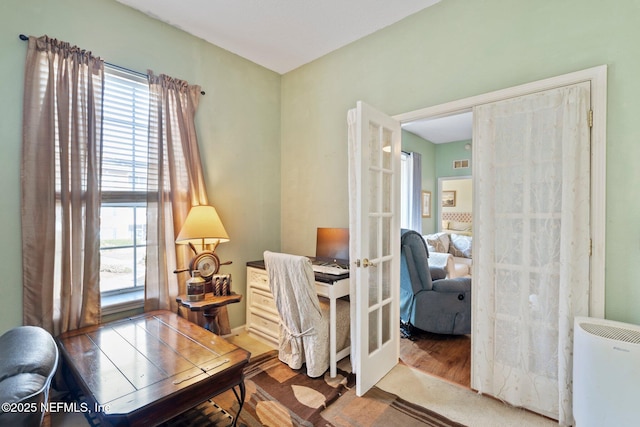 office space with hardwood / wood-style flooring and french doors