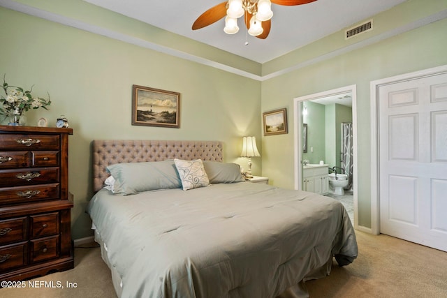 carpeted bedroom featuring connected bathroom and ceiling fan