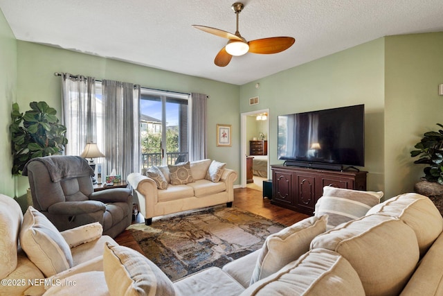 living room with hardwood / wood-style floors, a textured ceiling, and ceiling fan