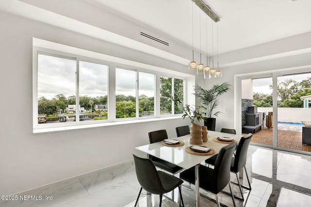 dining space featuring plenty of natural light