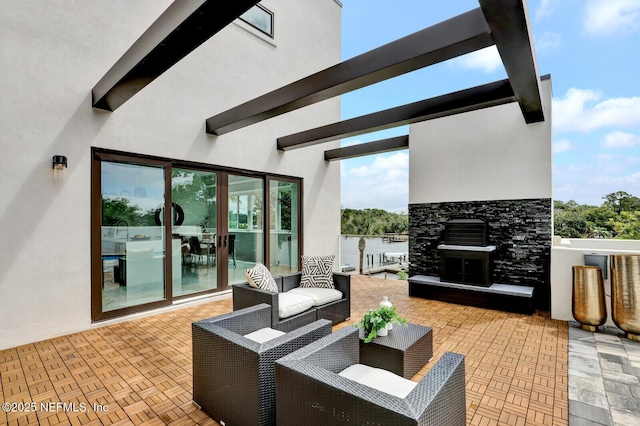 view of patio / terrace with an outdoor living space and a water view