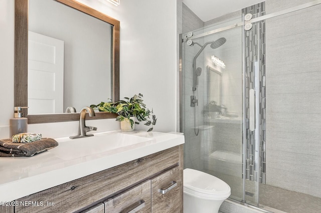 bathroom with vanity, toilet, and an enclosed shower