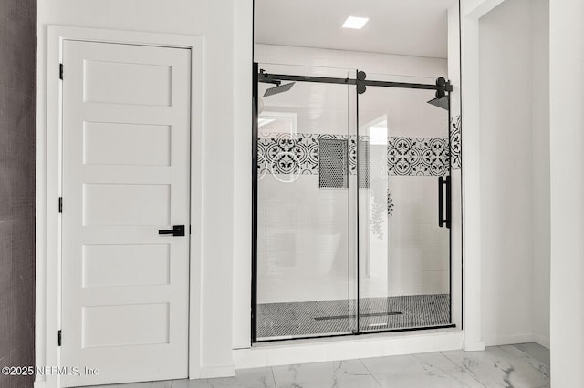 bathroom featuring a shower with shower door