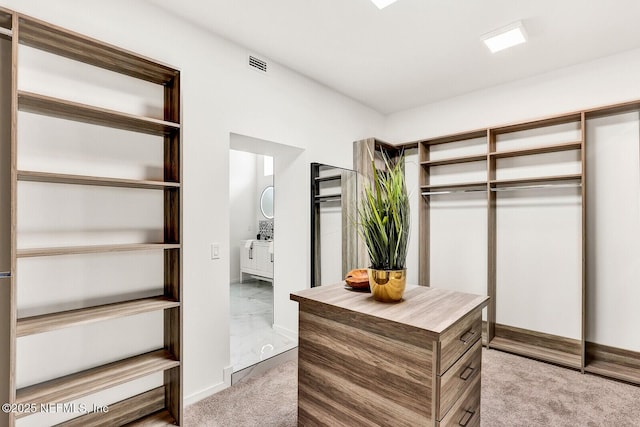 walk in closet featuring light carpet