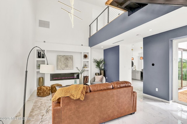 living room featuring a high ceiling, sink, and beverage cooler