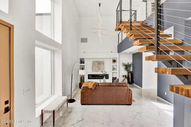 living room featuring a towering ceiling