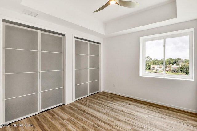 unfurnished bedroom featuring ceiling fan and light hardwood / wood-style flooring