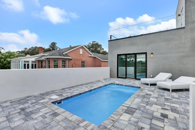 view of swimming pool with a patio area