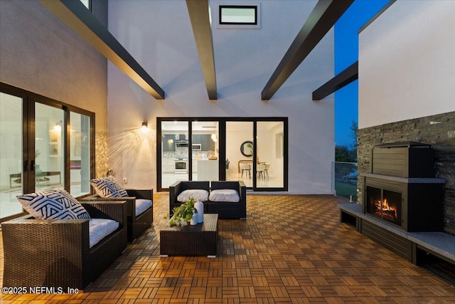 view of patio featuring an outdoor living space with a fireplace