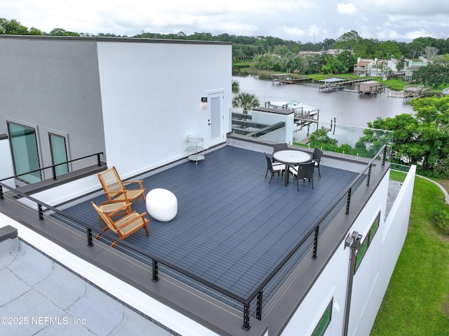 wooden terrace featuring a water view