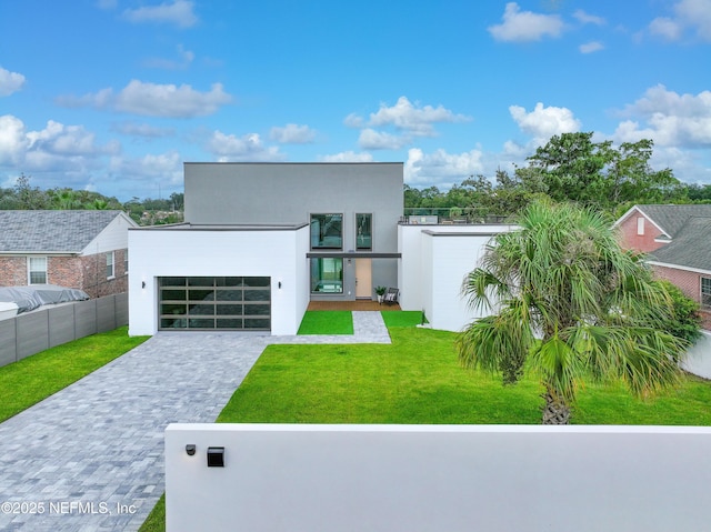 view of front facade with a garage and a front lawn