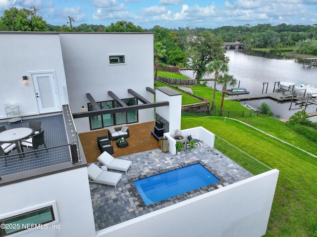 exterior space featuring a yard, a patio, and a water view