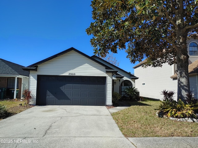 ranch-style home with a garage and driveway